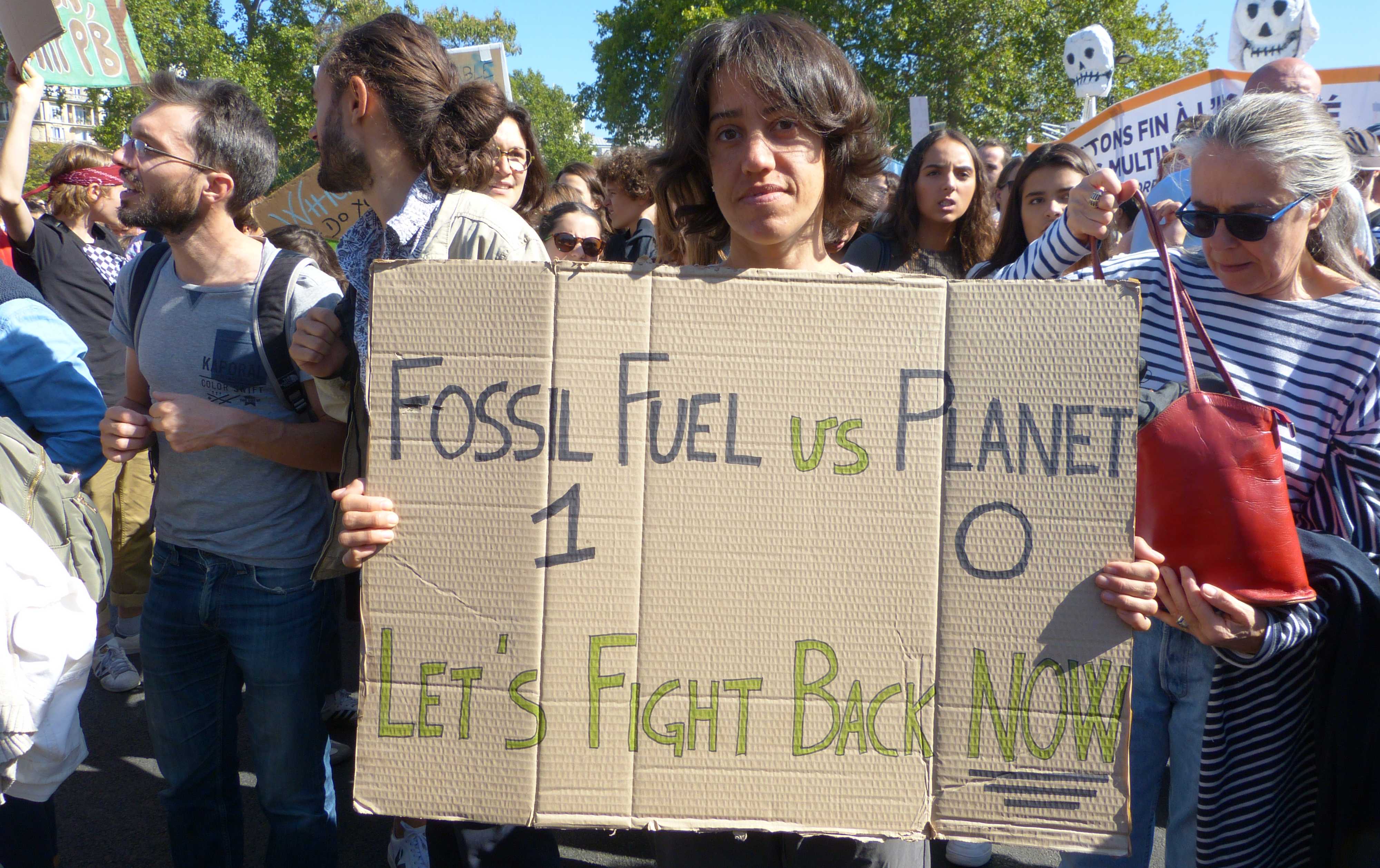 Holding my protest sign in Place de la Nation