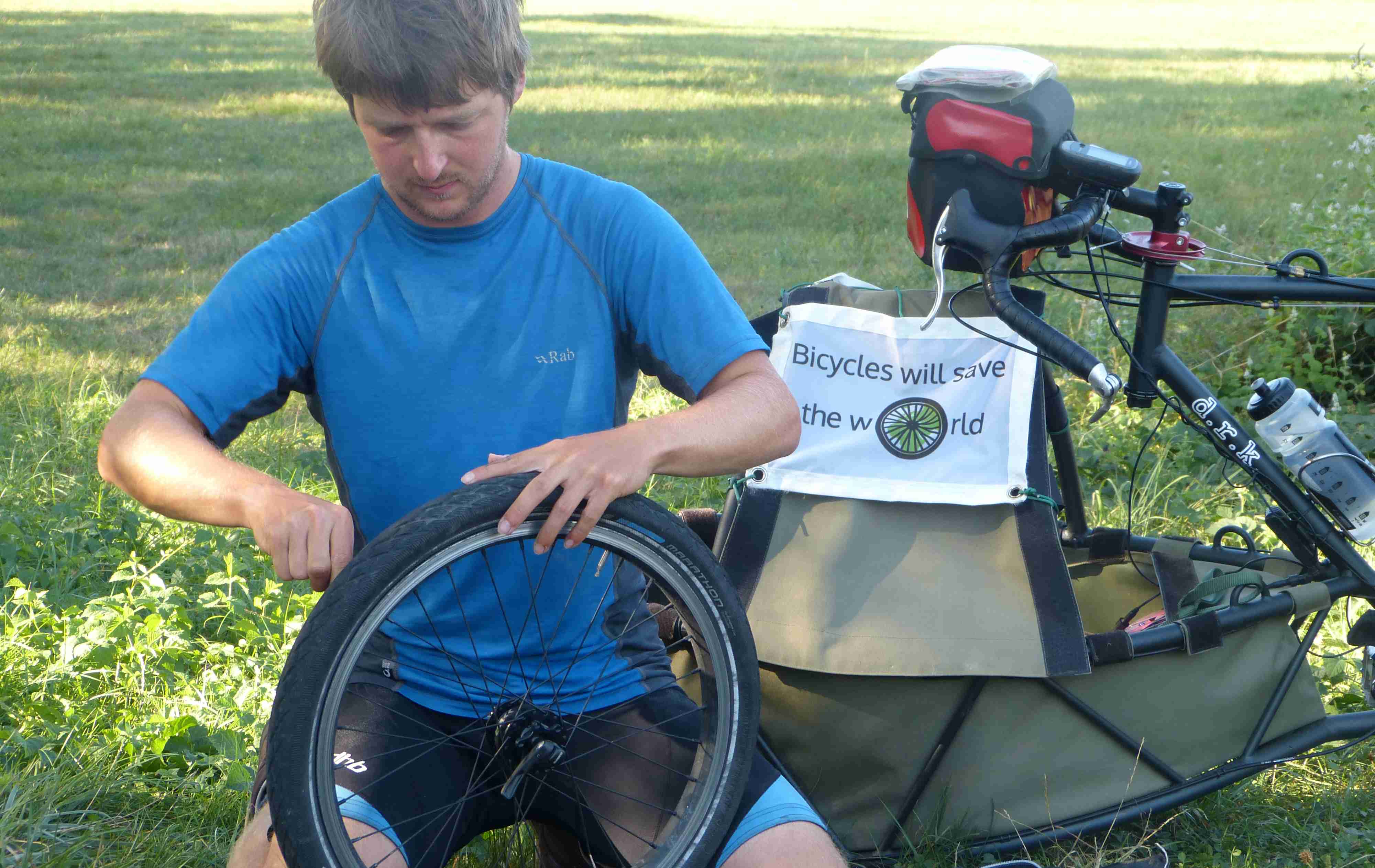 Daniel in the process of fixing the first puncture of the trip, in Dordogne