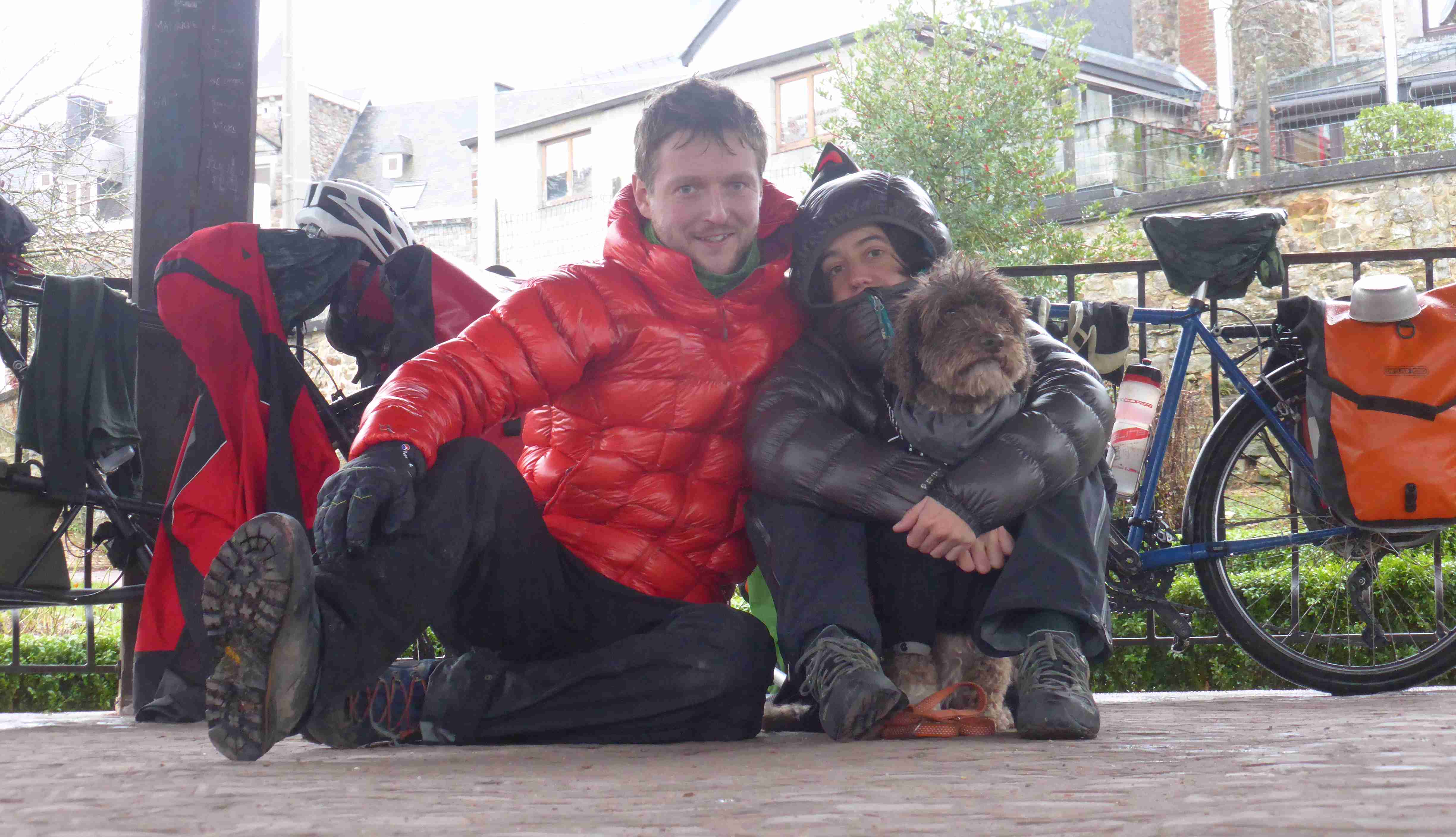 Enjoying shelter from the rain, a few moments before going back on the road and being approached by François