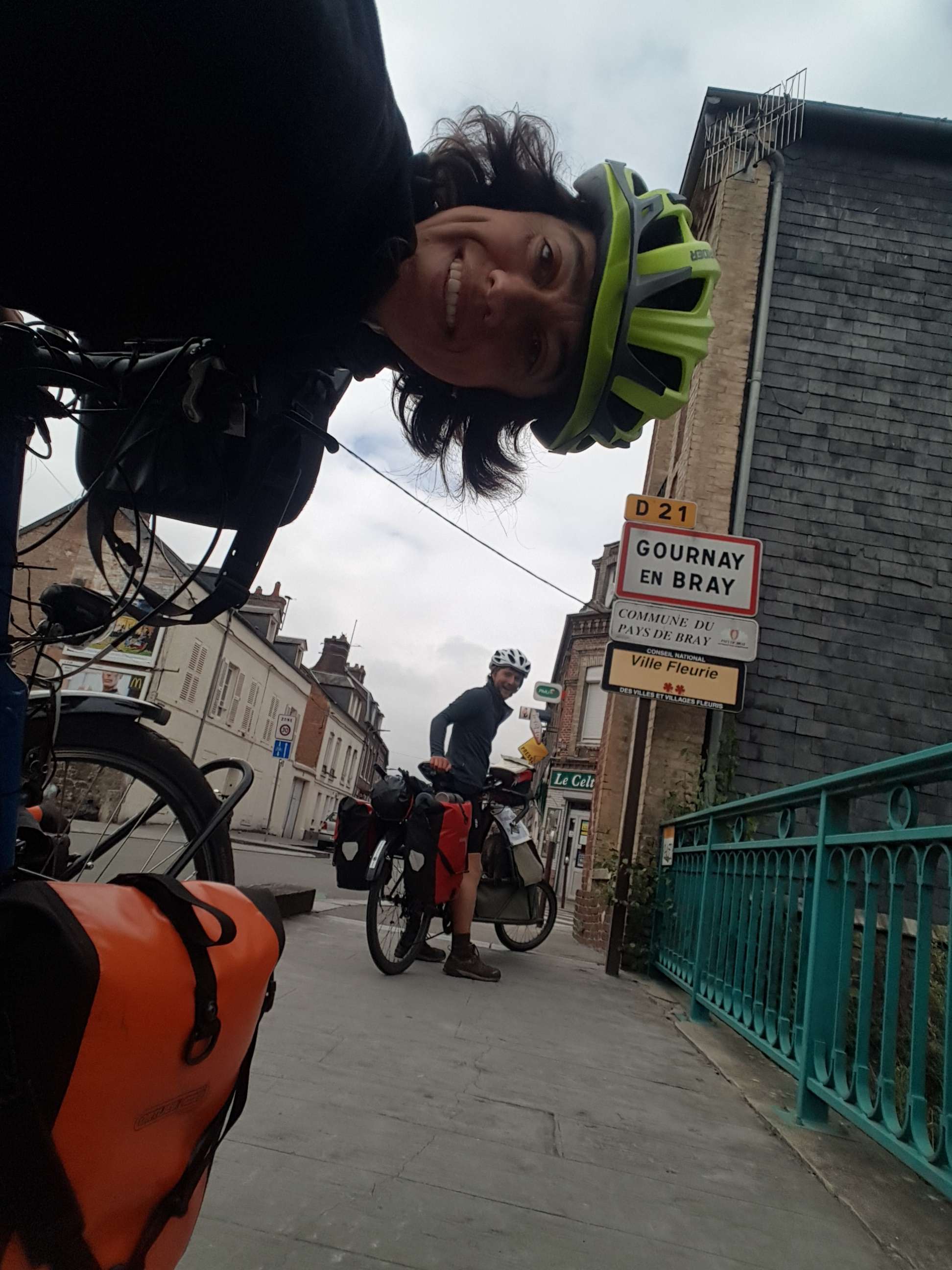 A typical picture of us and the bikes near a sign, hoping the Guinness World Record will enjoy our smiling efforts